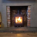 Roaring Fireplaces Installations wood burning stove in brick inlay