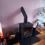 Roaring Fireplaces Installations stove installed at chimney breast.