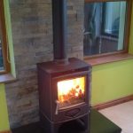 Roaring Fireplaces Installations stove with slate bachground